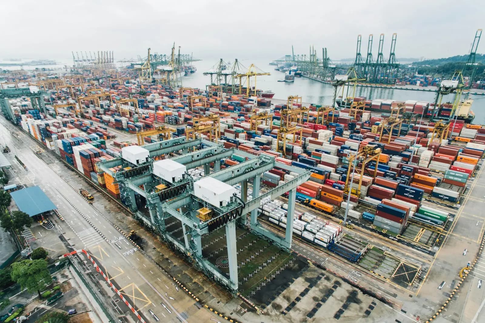 Aerial view of a container port with cranes and stacked cargo containers